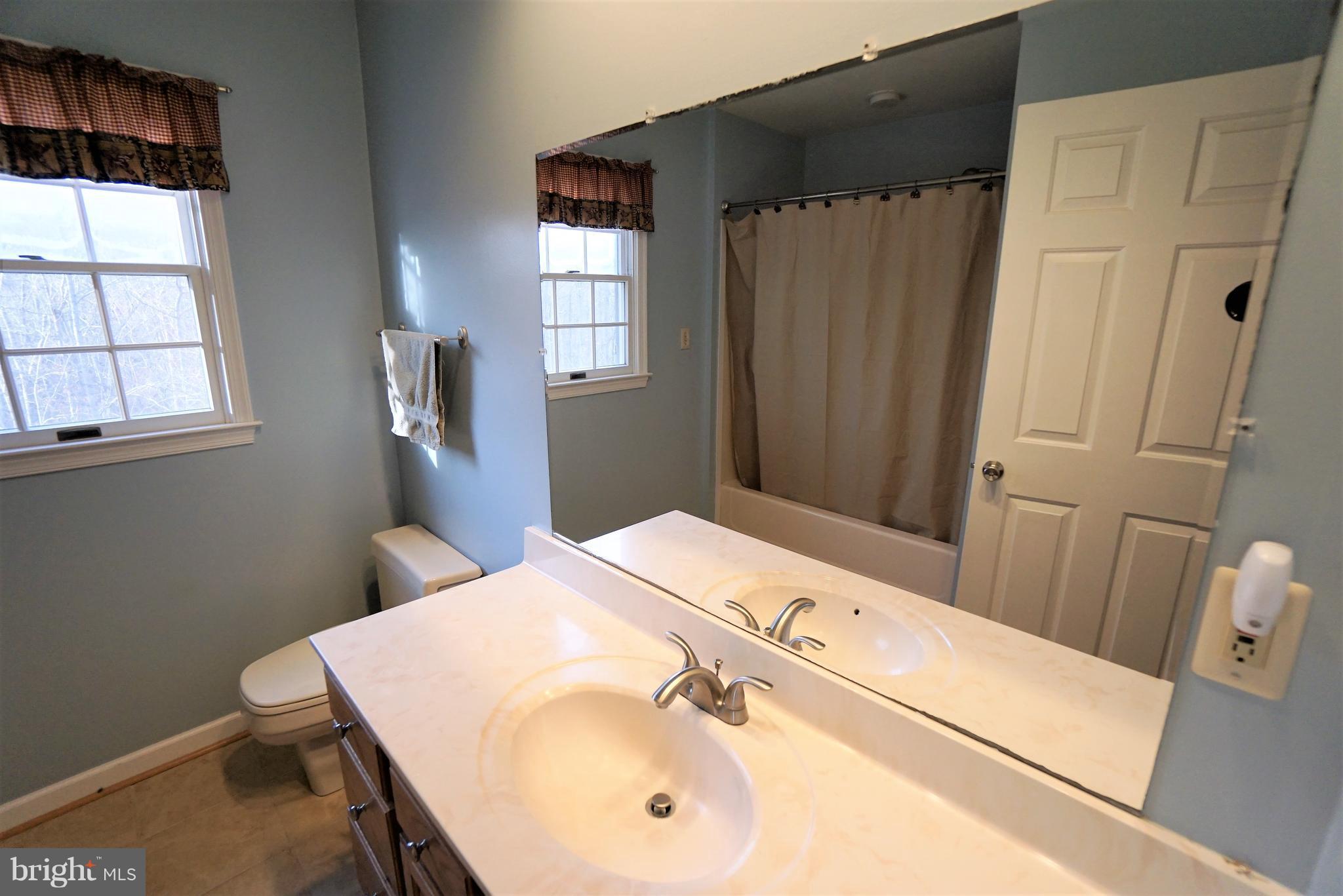 5940 Free State Road Marshall, VA 20115 - Photo 20 of 30 a bathroom with a sink a mirror and a shower
