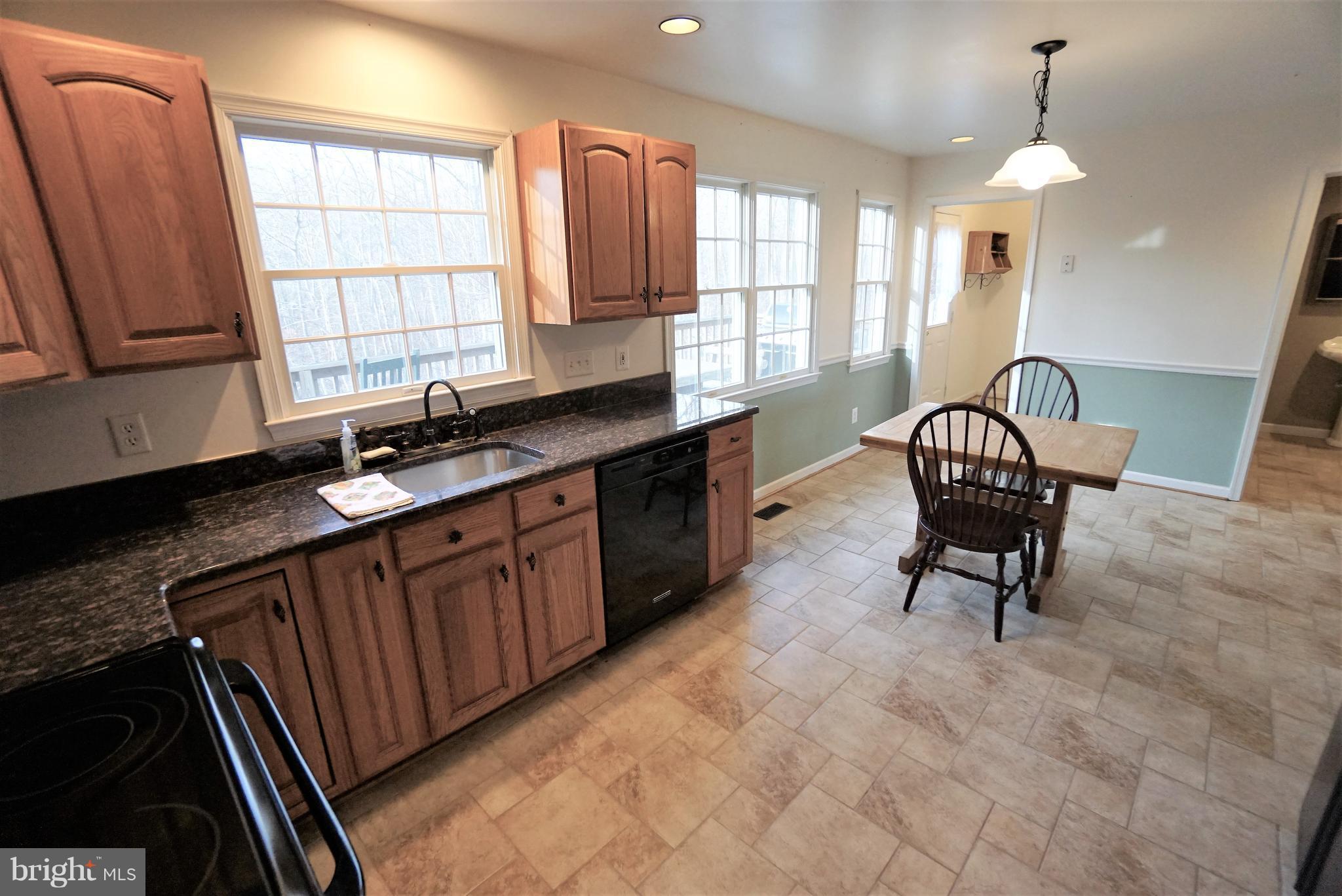 5940 Free State Road Marshall, VA 20115 - Photo 10 of 30 a kitchen with granite countertop a stove a sink and a dining table chair
