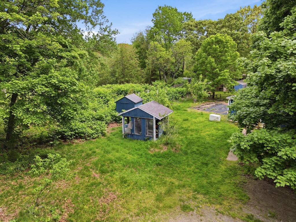 200 Stockbridge Road Scituate, MA 02066 - Photo 4 of 14 a view of a garden with a bench