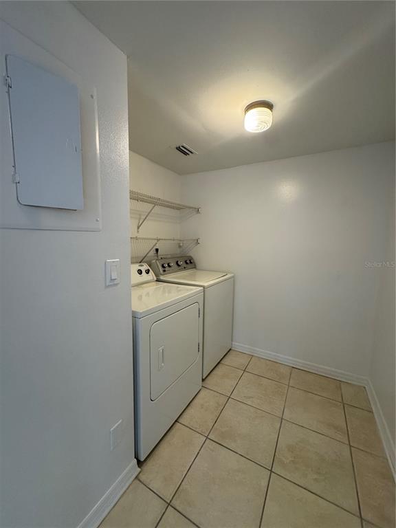 8213 Sun Spring Circle, Unit 61 Orlando, FL 32825 - Photo 15 of 44 a utility room with cabinets washer and dryer