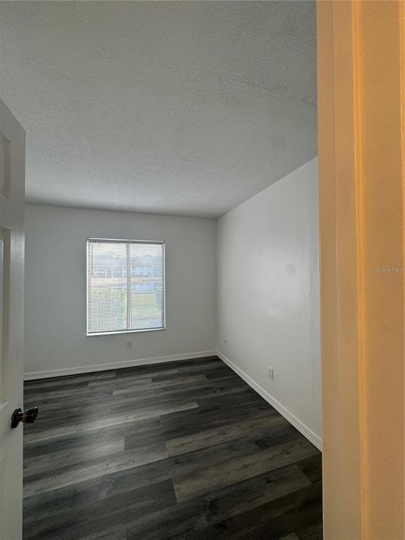 8213 Sun Spring Circle, Unit 61 Orlando, FL 32825 - Photo 17 of 44 wooden floor in an empty room