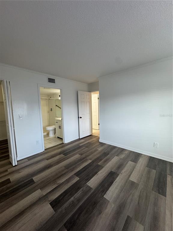 8213 Sun Spring Circle, Unit 61 Orlando, FL 32825 - Photo 22 of 44 a bedroom with a bed and a mirror