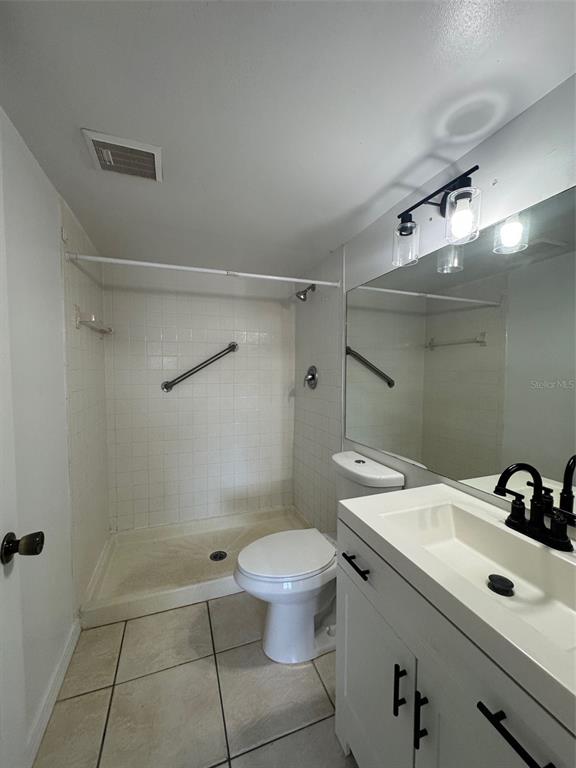 8213 Sun Spring Circle, Unit 61 Orlando, FL 32825 - Photo 25 of 44 a bathroom with a sink toilet and shower