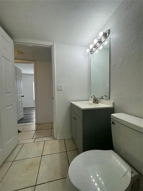 8213 Sun Spring Circle, Unit 61 Orlando, FL 32825 - Photo 29 of 44 a bathroom with a toilet sink and mirror