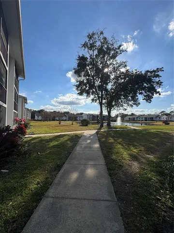 a view of swimming pool outdoor seating and yard