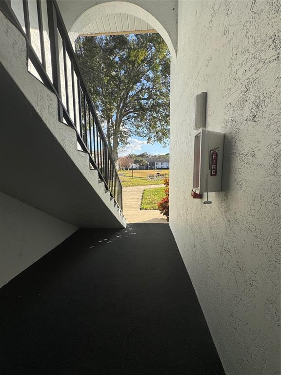 8213 Sun Spring Circle, Unit 61 Orlando, FL 32825 - Photo 36 of 44 a view of a hallway with wooden floor and a entryway
