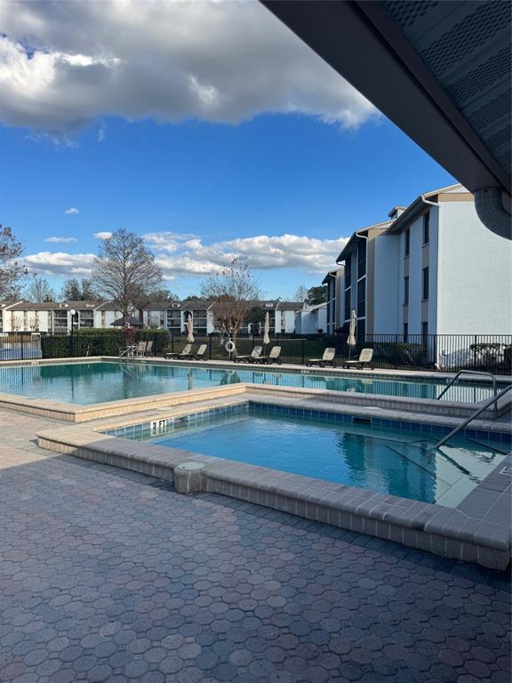 8213 Sun Spring Circle, Unit 61 Orlando, FL 32825 - Photo 40 of 44 a view of a lake with a building in the background