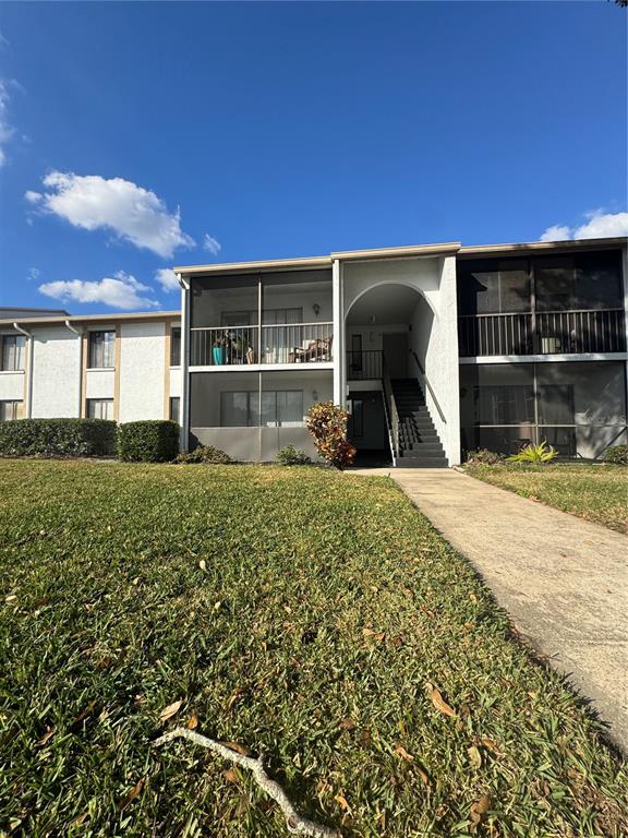 8213 Sun Spring Circle, Unit 61 Orlando, FL 32825 - Photo 4 of 44 a front view of a house with a yard