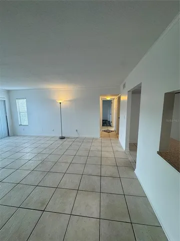 a view of a livingroom with an empty space and window