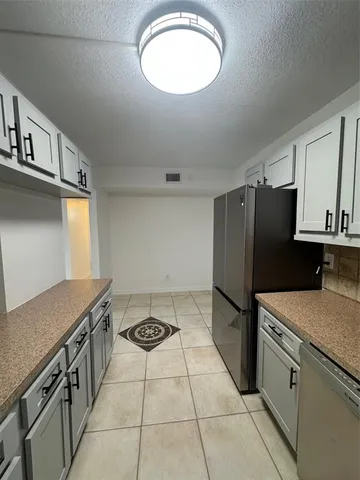 a kitchen with stainless steel appliances granite countertop a stove a refrigerator and a sink