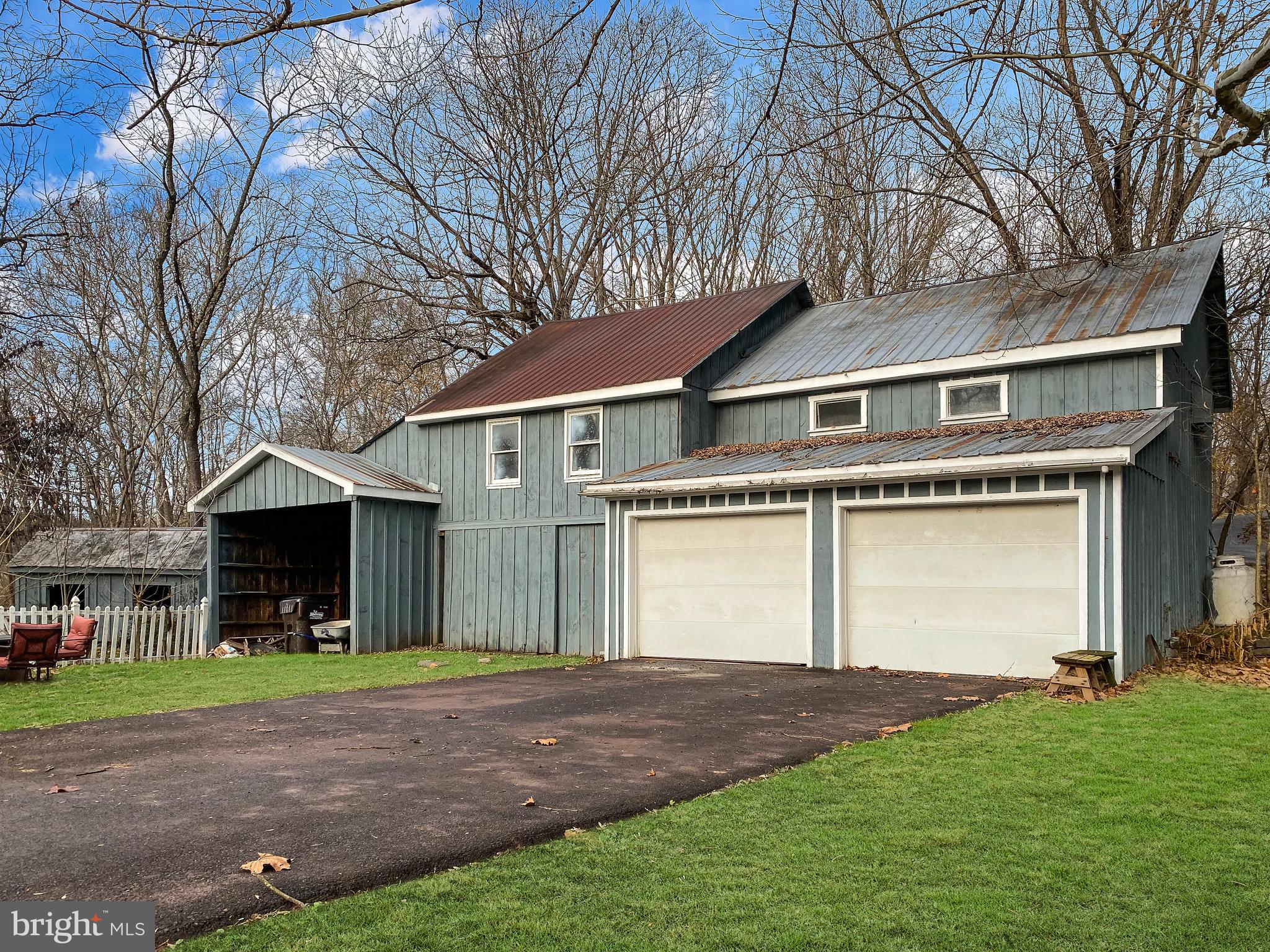 589 Groffs Mill Road Harleysville, PA 19438 - Photo 10 of 14 a front view of a house with a yard and garage