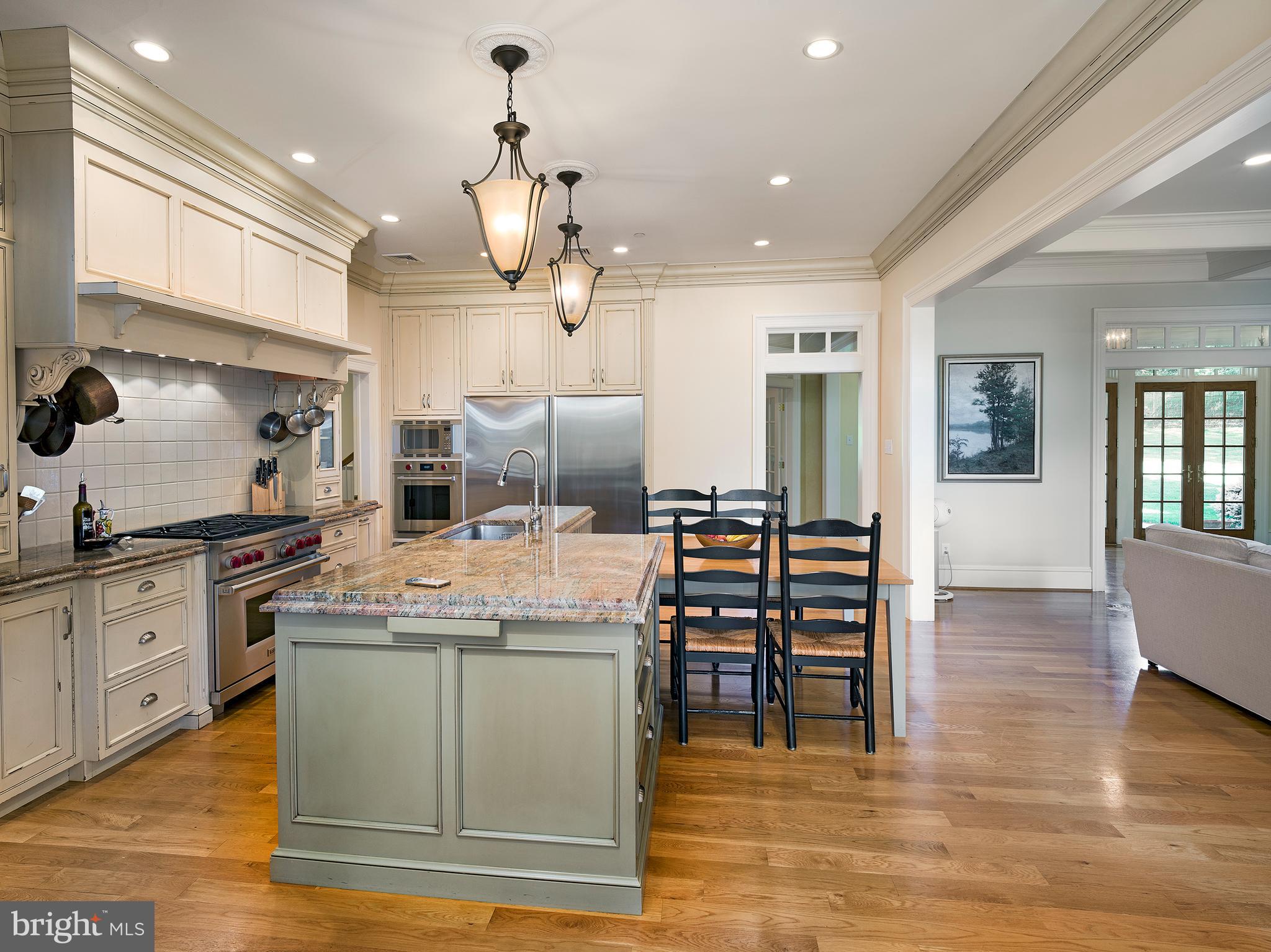 102 Springhouse Lane Newtown Square, PA 19073 - Photo 21 of 80 a kitchen with stainless steel appliances granite countertop a sink a stove and a wooden floors
