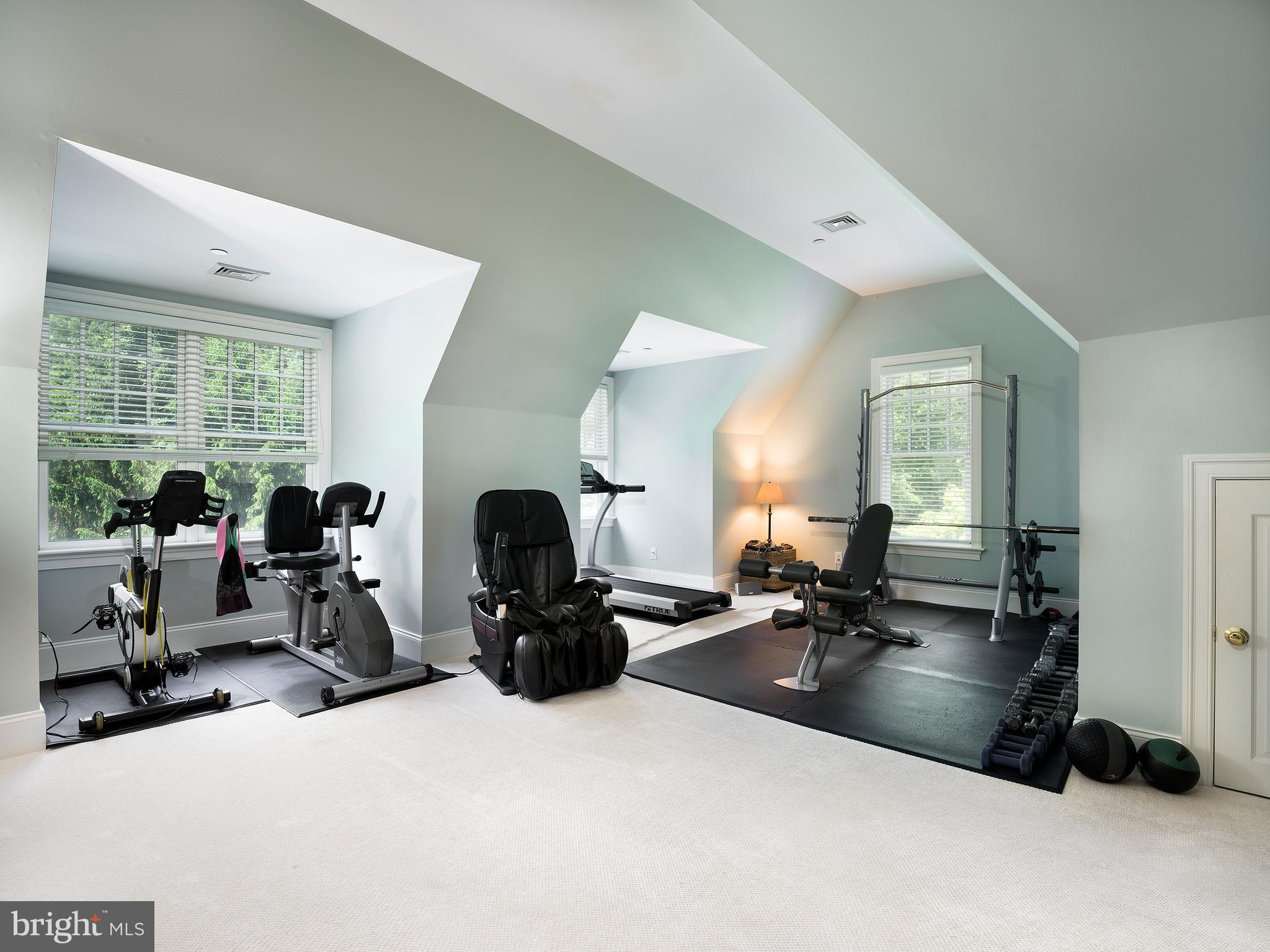 102 Springhouse Lane Newtown Square, PA 19073 - Photo 60 of 80 a living room with furniture a large window and gym equipment