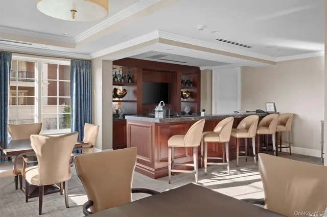 a dining room with furniture a rug and a chandelier