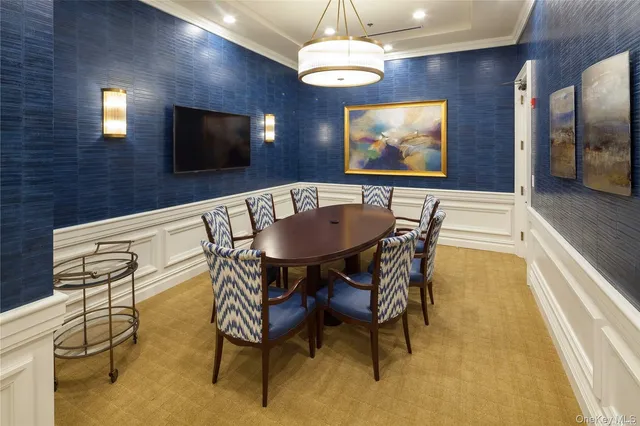 a view of a dining room with furniture wooden floor and a chandelier