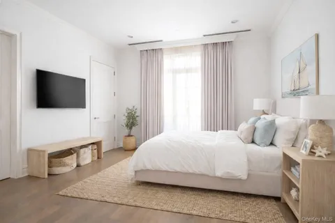 a bedroom with a bed and a flat screen television