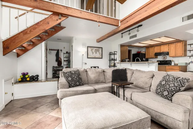 a living room with furniture and a ceiling fan