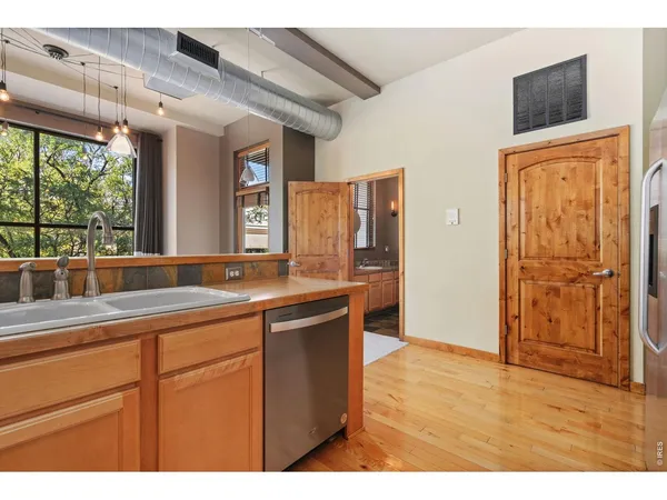a kitchen with a sink and wooden cabinets