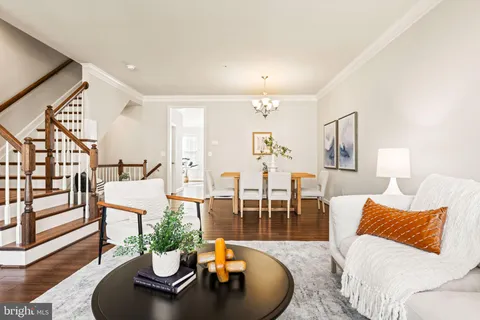 a kitchen with a sink stove and wooden floor
