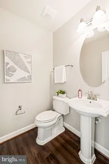 a kitchen with stainless steel appliances granite countertop a sink a stove and a wooden floors