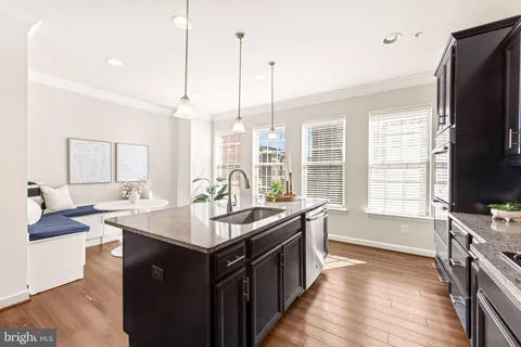 a kitchen with granite countertop stainless steel appliances and wooden cabinets