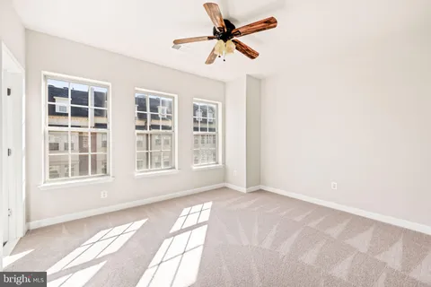 a bathroom with a granite countertop bathtub a sink and a large mirror
