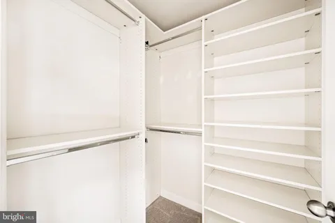 a bathroom with a granite countertop sink a large mirror and a shower