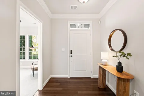 a view of a workspace with furniture and a potted plant