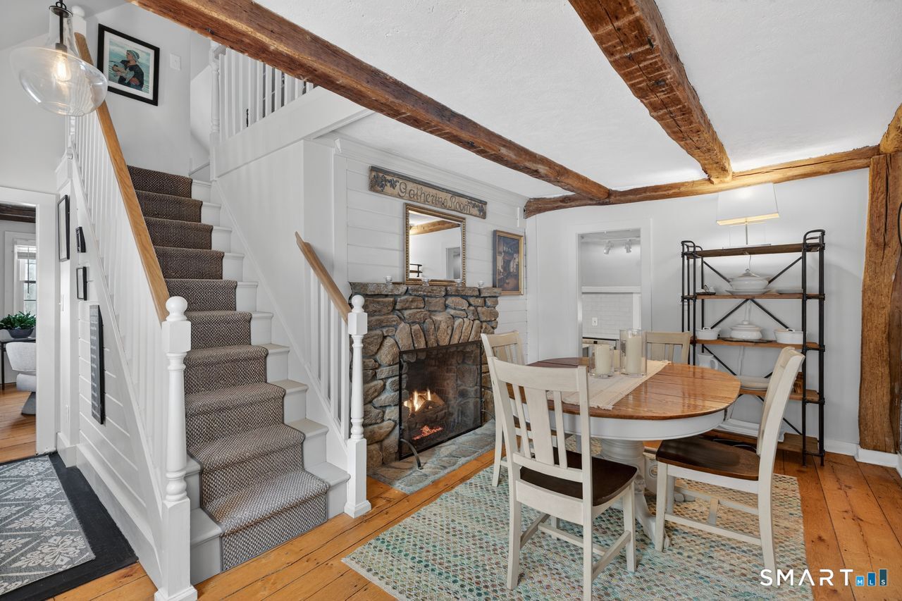 279 Roast Meat Hill Road Killingworth, CT 06419 - Photo 3 of 24 Just off the main entry, dining room with field stone fireplace and propane insert.
