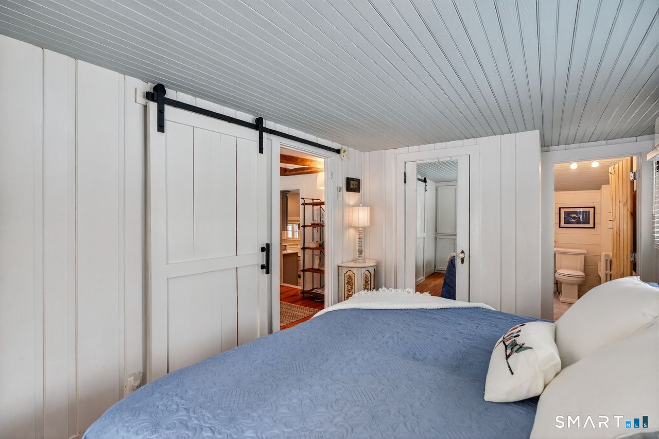 279 Roast Meat Hill Road Killingworth, CT 06419 - Photo 5 of 24 The first floor primary is large enough for a king-size bed and offers built-ins for storage.