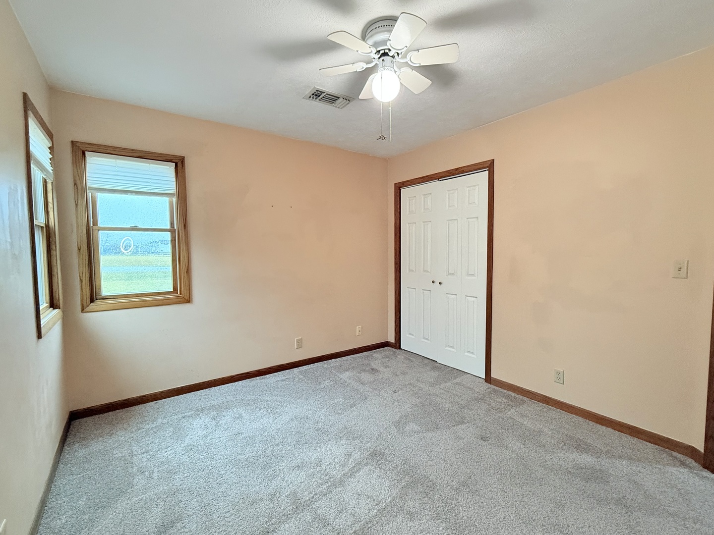 101 East 10th Street Gridley, IL 61744 - Photo 12 of 17 an empty room with windows and fan