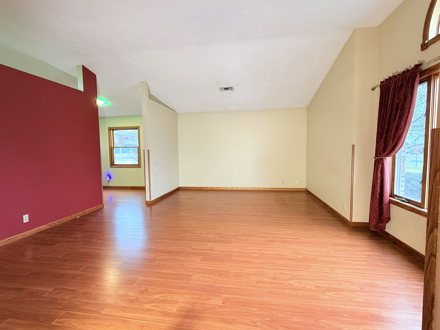 101 East 10th Street Gridley, IL 61744 - Photo 4 of 17 a view of an empty room with wooden floor and a window