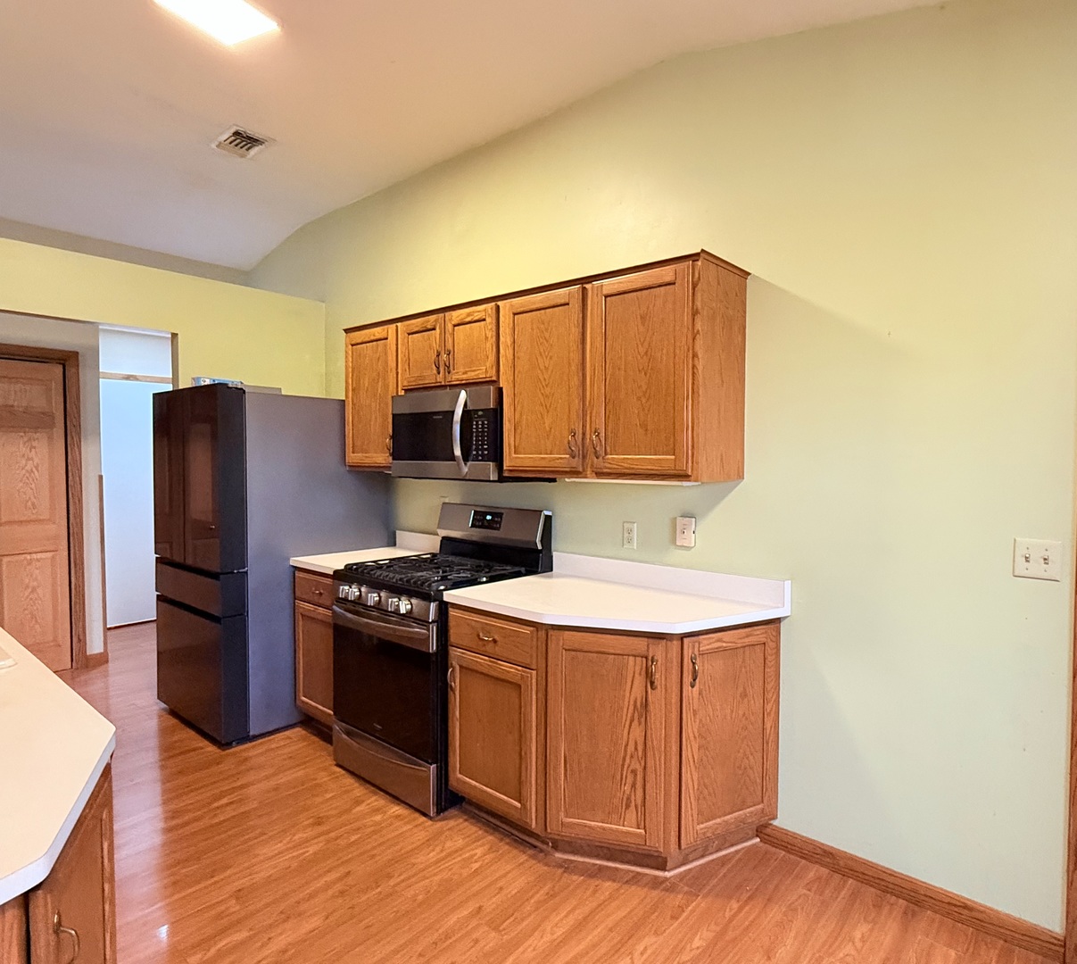 101 East 10th Street Gridley, IL 61744 - Photo 7 of 17 a kitchen with stainless steel appliances a sink a stove a refrigerator cabinets and a counter top space