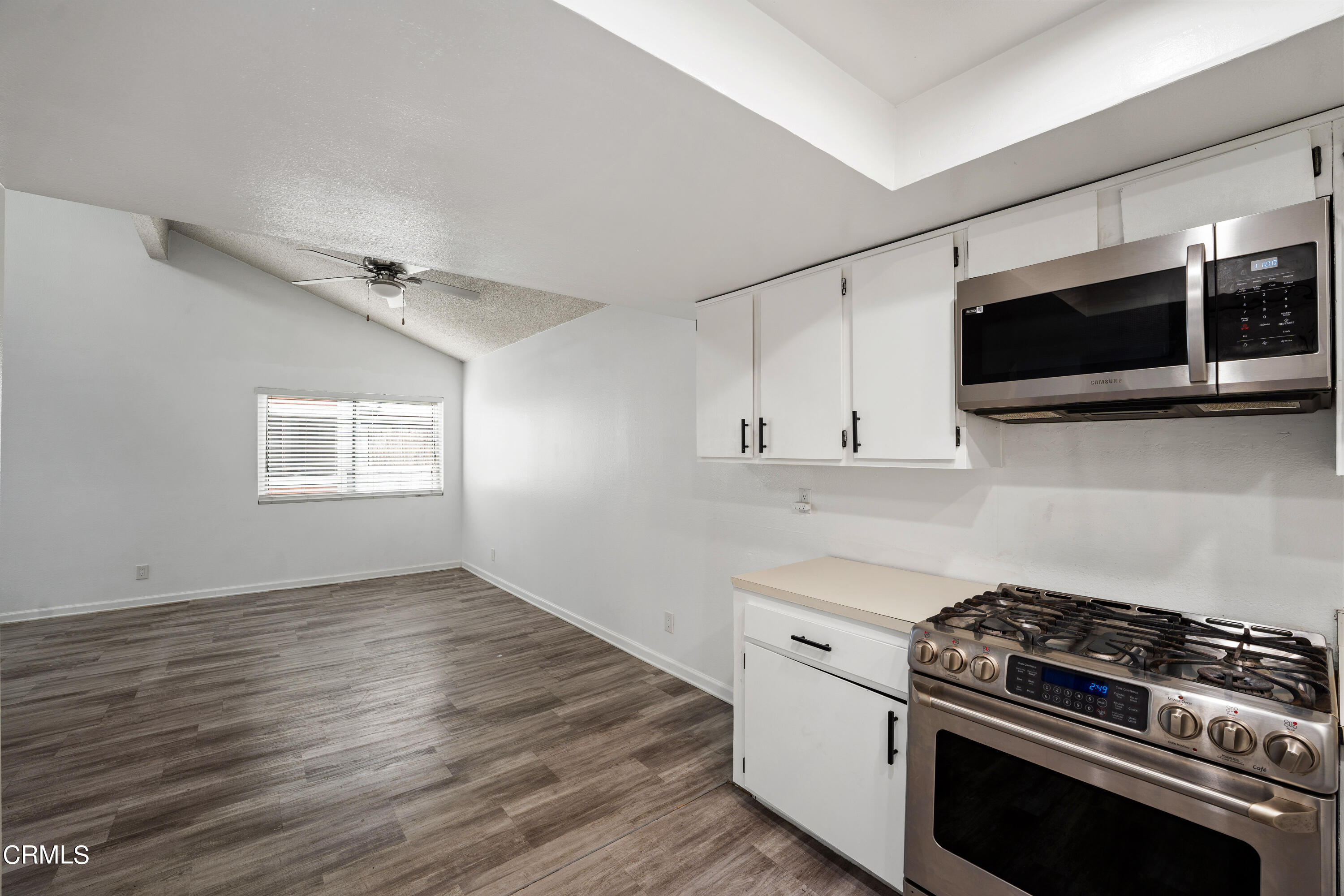 5218 Longfellow Way Oxnard, CA 93033 - Photo 5 of 19 a kitchen with stainless steel appliances granite countertop a stove and a microwave