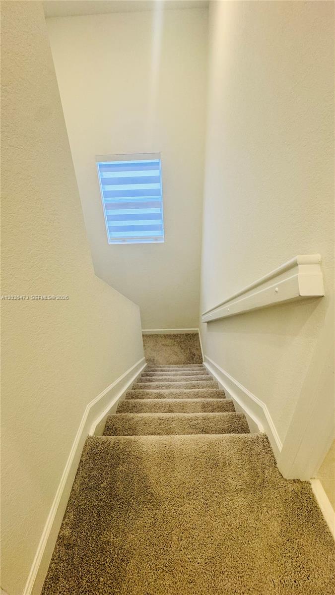 19479 Southwest 340th Street, Unit 1 Homestead, FL 33034 - Photo 29 of 58 a view of a room with stairs
