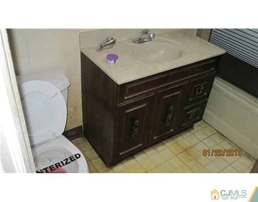 25 Caldwell Road Edison, NJ 08817 - Photo 12 of 14 a bathroom with a sink toilet and a vanity