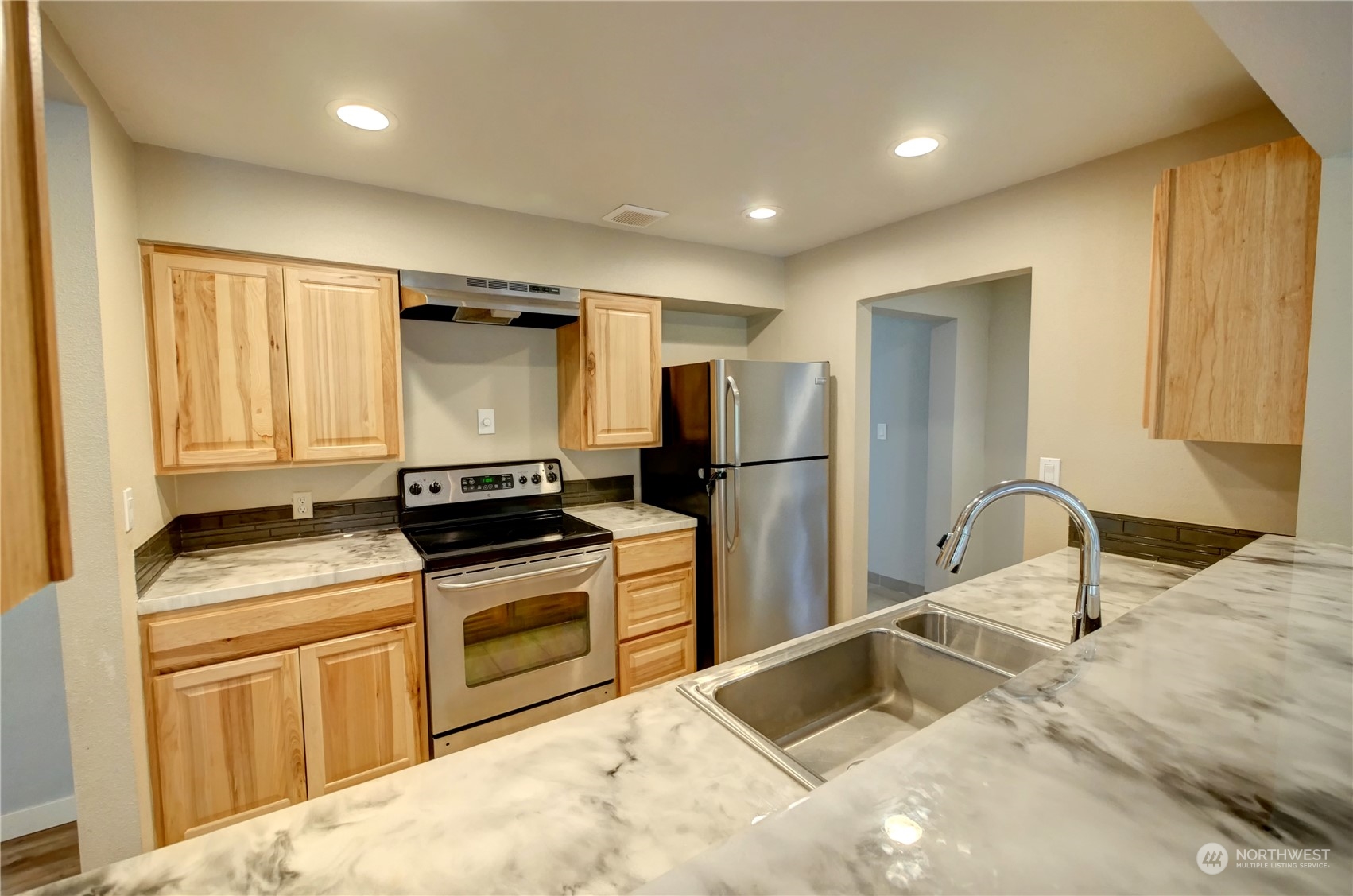 26 Middle Lane Road Omak, WA 98841 - Photo 10 of 38 a kitchen with a stove sink and refrigerator