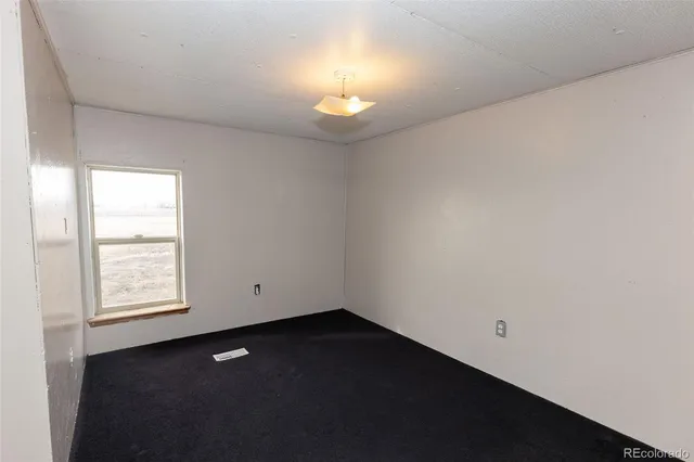 an empty room with a empty space and a window