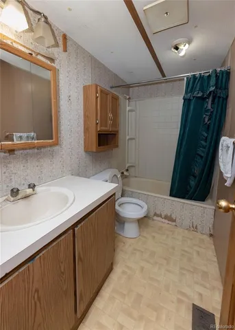 a bathroom with a double vanity sink toilet and mirror