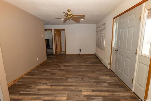 a view of a hallway with wooden floor and closet