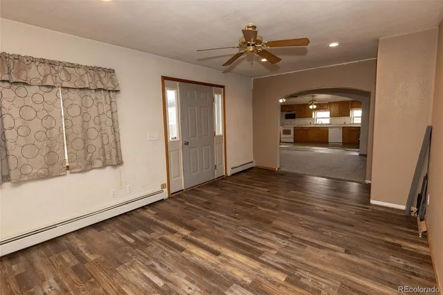 wooden floor in an empty room with a window