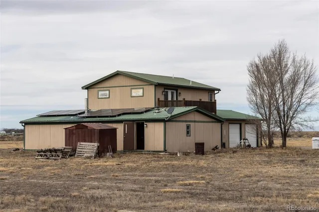 a view of a house with wooden fence