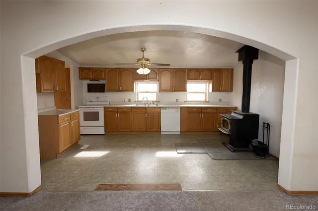 a kitchen with cabinets and chairs
