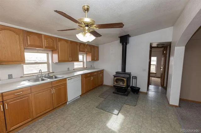 a kitchen with a sink and wooden cabinets