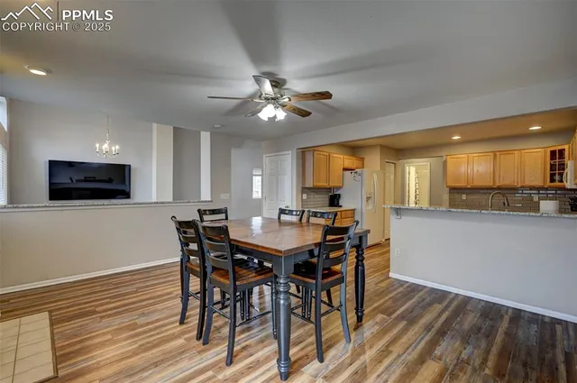 a view of a dining room with furniture and a kitchen