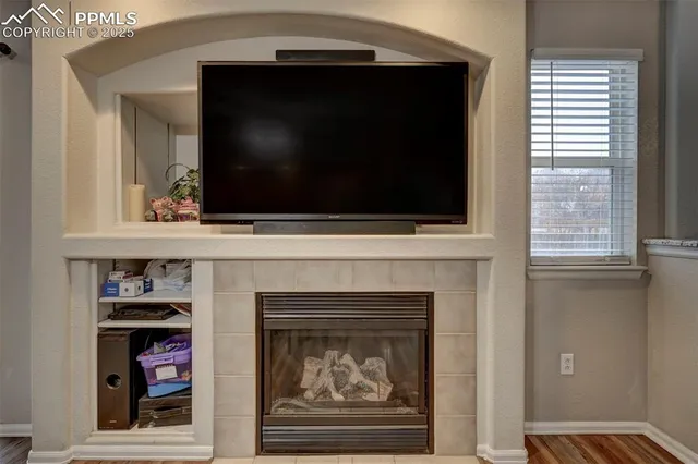 a living room with a fireplace and a flat screen tv