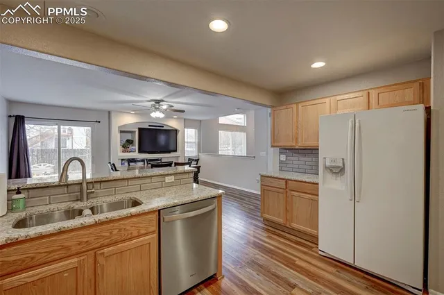a kitchen with kitchen island a sink appliances and cabinets