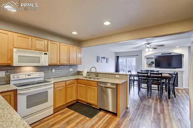 a kitchen with a sink cabinets and wooden floor