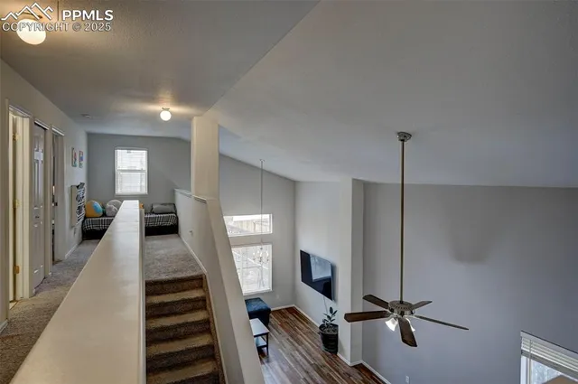 a view of a hallway with a flat screen tv
