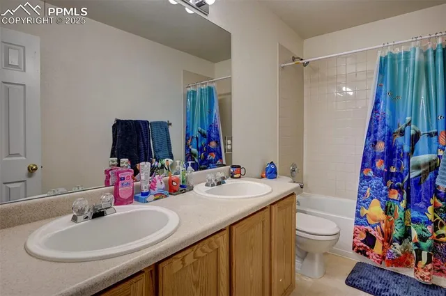 a bathroom with a sink vanity mirror and toilet